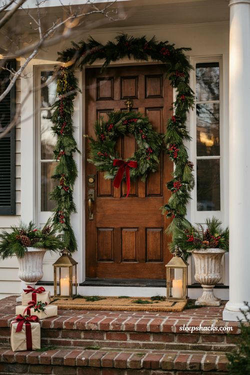 Traditional christmas porch decor with pine garland framing the front door and classic holiday styling