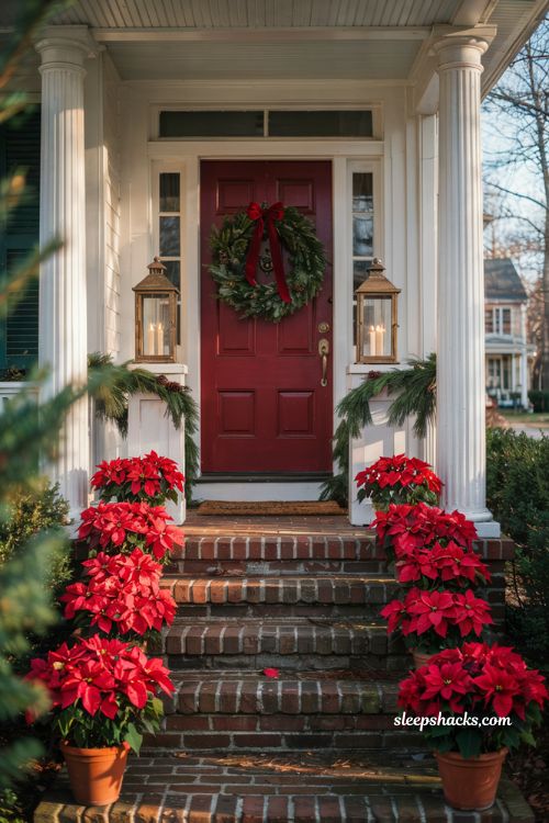 Traditional christmas porch decor with red poinsettias lining the front steps