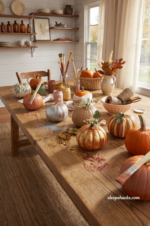 Unique pumpkin decorating ideas with creative painted pumpkins and cozy fall craft table display