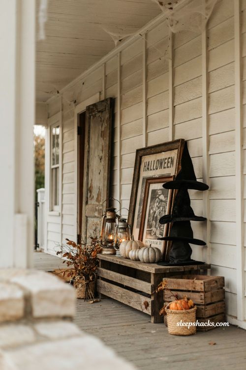 Vintage Halloween exterior decorations with witch hats, antique lanterns, and black and white accents 