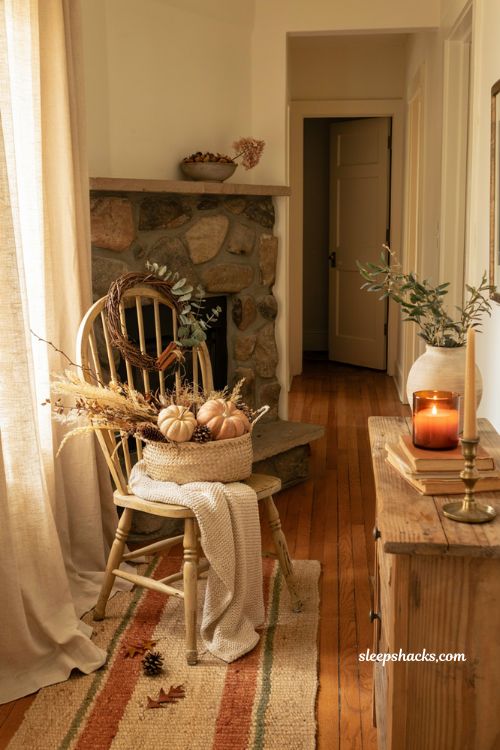 Vintage chair fall decor ideas with pumpkins wreath and cozy entryway styling