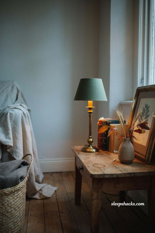 Vintage fall decor with cozy lighting in a dark living room corner