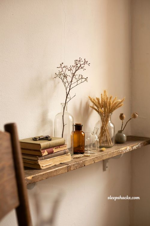 Vintage fall decor with old apothecary bottles and dried branches