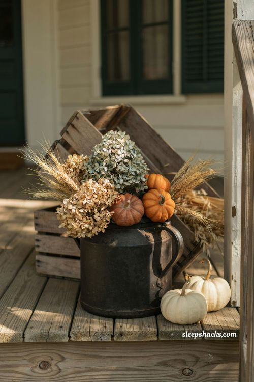 Vintage fall porch decor with cast iron kettle and dried wheat