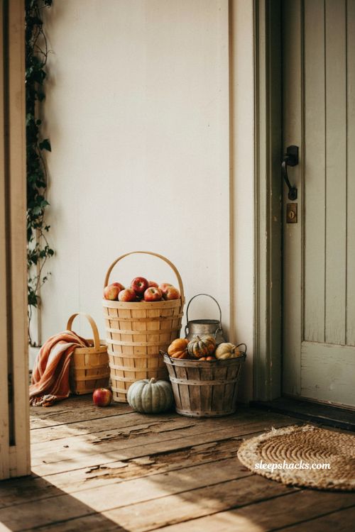 Vintage fall porch decor with old apple baskets and autumn gourds
