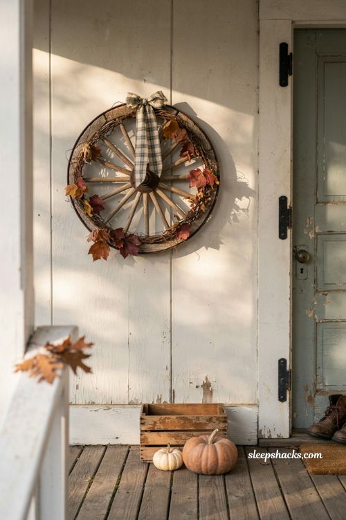 Vintage fall porch decor with rustic wagon wheel wreath and plaid ribbon