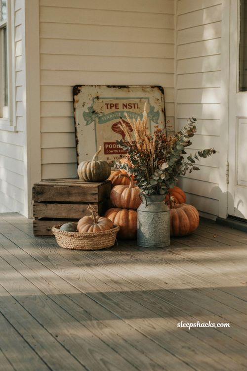 Vintage fall porch decor with weathered farmhouse sign and pumpkins