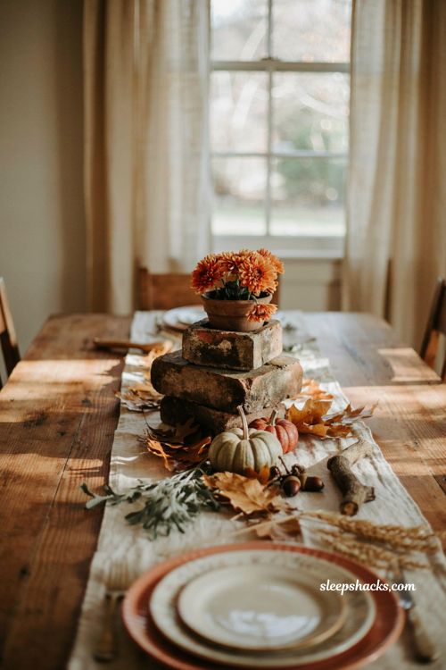 Vintage fall tablescapes with stacked brick molds and orange mums