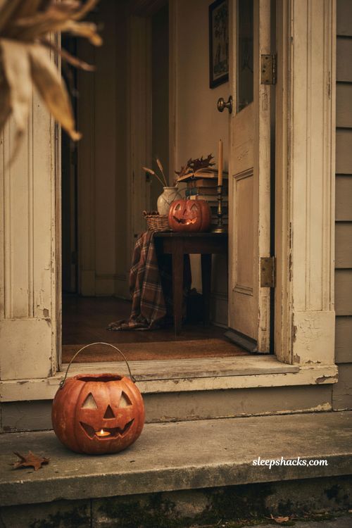 Vintage paper mache pumpkin bucket decor with glowing faces and nostalgic Halloween entryway
