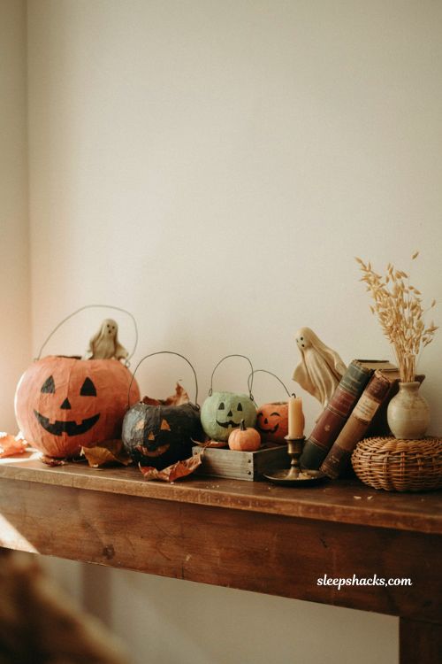 Vintage papier mache pumpkin buckets with ghost figures and nostalgic Halloween shelf decor