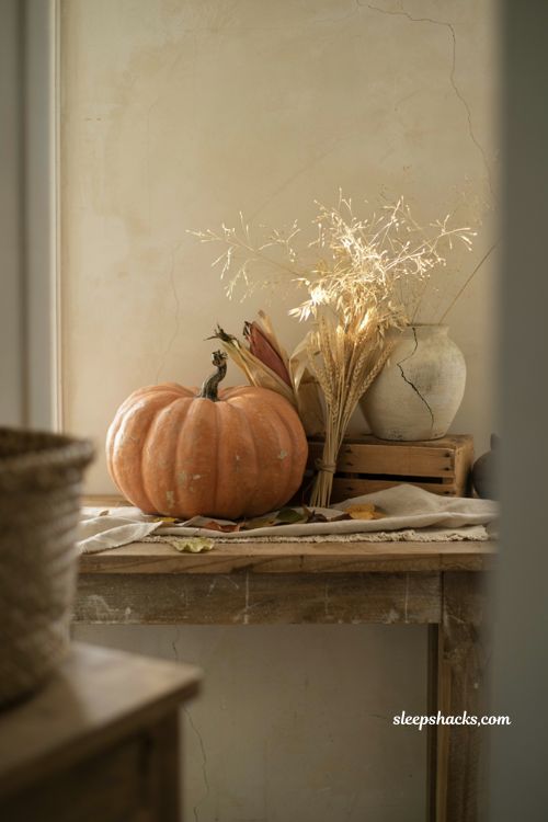 Vintage pumpkin decor with wheat bundles and harvest textures