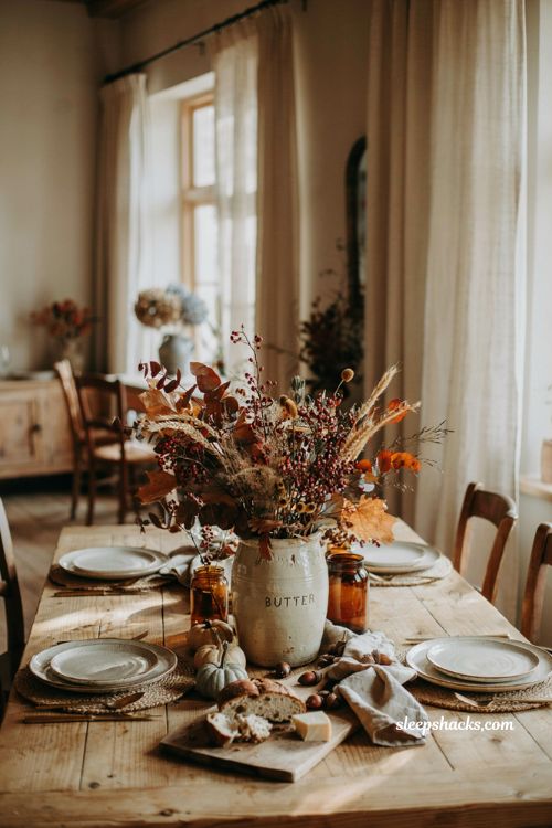 Vintage stoneware crock fall centerpiece with dried florals and amber glass
