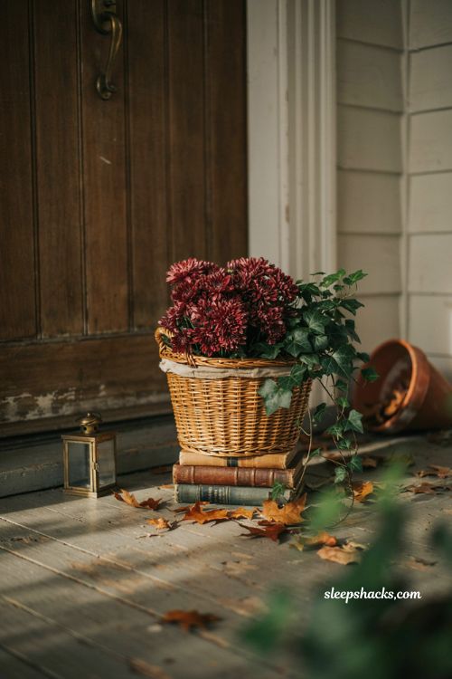 Vintage wooden crate fall porch decor with pumpkins lanterns and dried wheat 