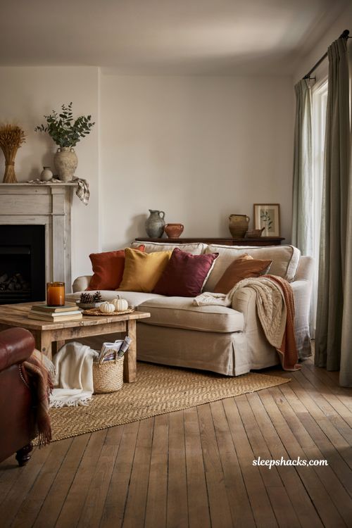 Warm toned throw pillows and blankets for cozy farmhouse fall living room decor ideas