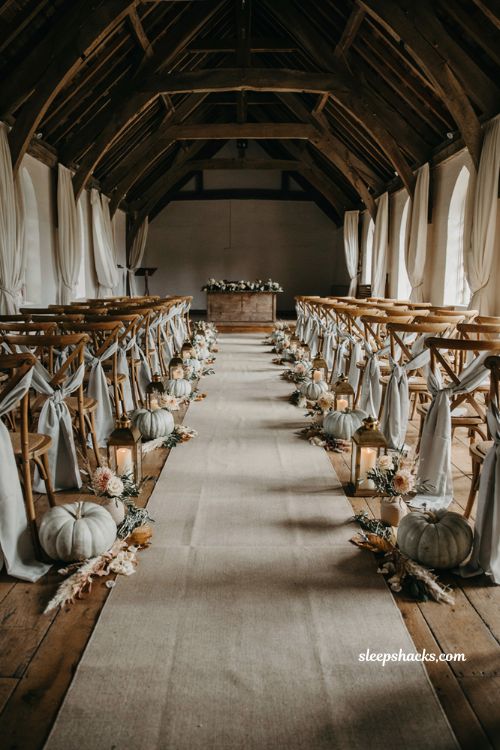 White and green pumpkin wedding ceremony aisle with elegant autumn seating decor
