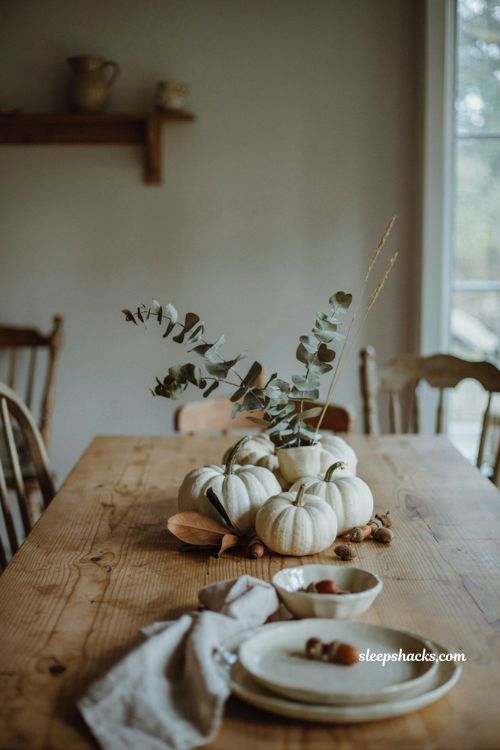 White pumpkin centerpiece with acorns and dried eucalyptus for natural fall table decor 