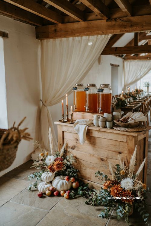 White pumpkin wedding apple cider bar with elegant autumn drink station decor