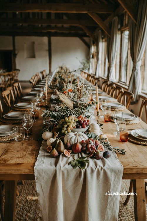White pumpkin wedding centerpiece with seasonal harvest produce on a farmhouse reception table