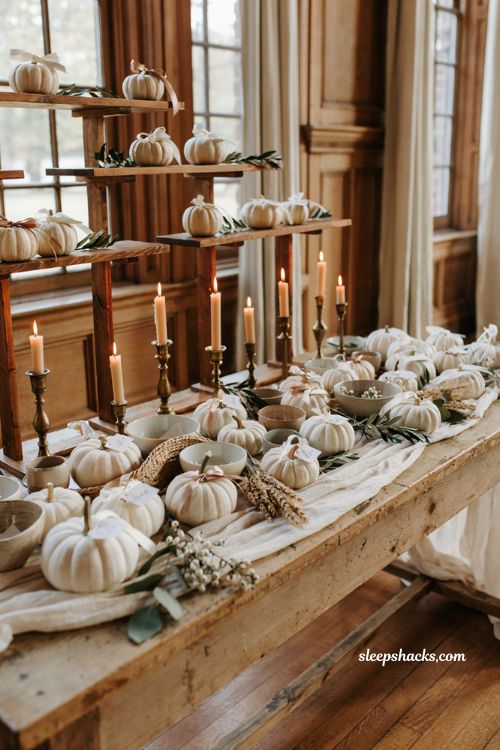 White pumpkin wedding escort card display with elegant autumn entry table
