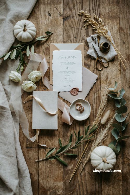 White pumpkin wedding invitation flat lay with elegant autumn stationery styling