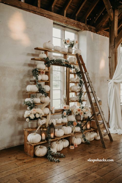 White pumpkin wedding photo backdrop with elegant autumn reception entrance decor
