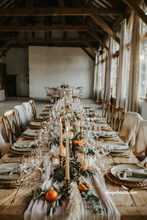 White pumpkin wedding reception table with greenery candles and autumn citrus decor