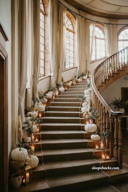 White pumpkin wedding staircase entrance with elegant autumn candle decor