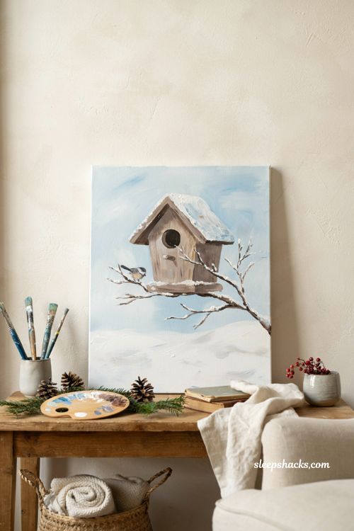 Winter birdhouse painting on canvas with snow and soft blue sky