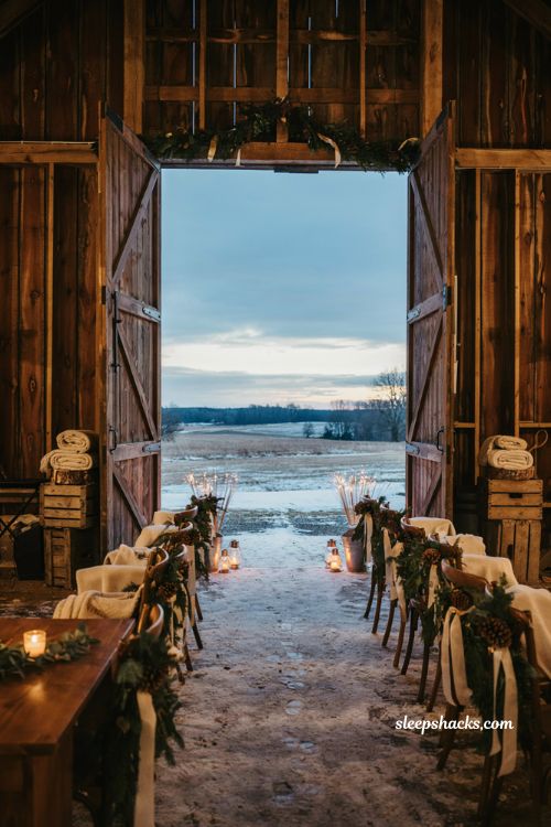 Winter wedding sparkler exit ideas with snowy outdoor aisle and rustic lights