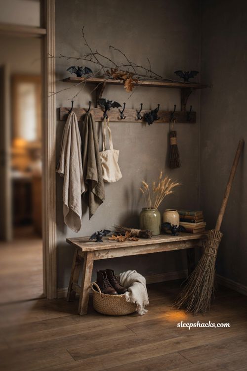 Witchy Halloween mudroom entryway with broom bats and rustic decor
