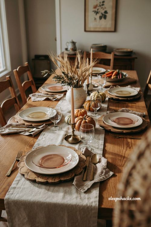 Wooden chargers with blush and amber glass plates for Thanksgiving table decor