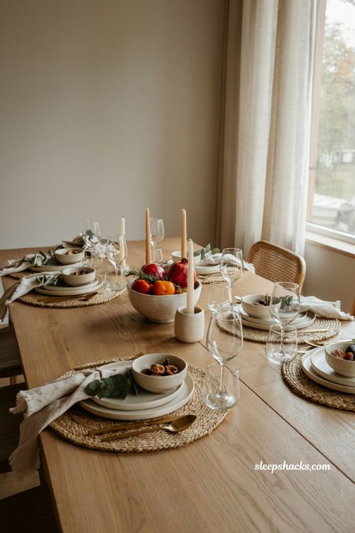 asymmetrical Thanksgiving table with off center plates and rolled linen napkins