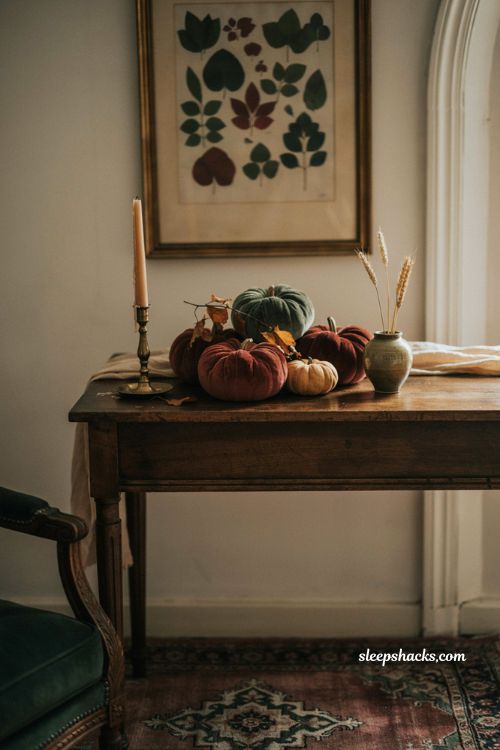 classy halloween decor with burgundy velvet pumpkins on a console table