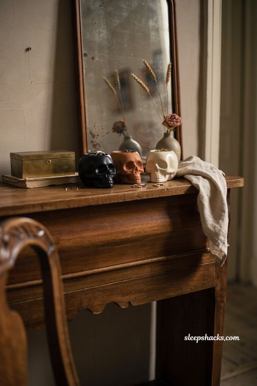 classy halloween decor with skull trinket dishes on an antique dresser