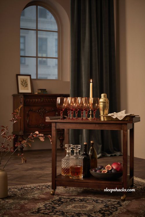 classy halloween decor with smoky amber goblets on a vintage bar cart