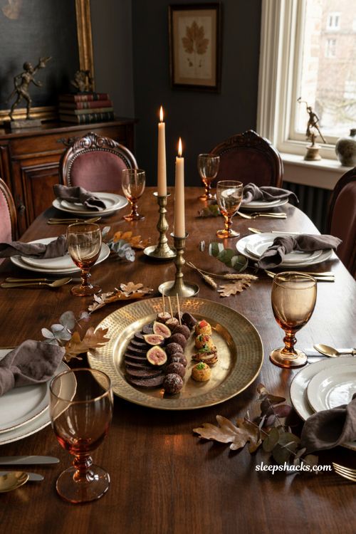 classy halloween table decor with a gold hammered platter and amber goblets