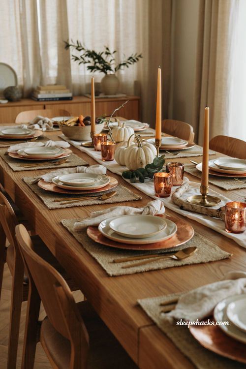 copper and brass Thanksgiving table with white pumpkins and warm modern holiday decor