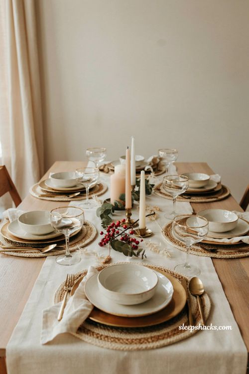 cream and gold Thanksgiving table with woven placemats and elegant modern holiday decor