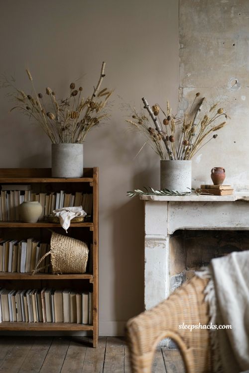 dried stems in cement pots for cozy fall bookshelf and mantel decor