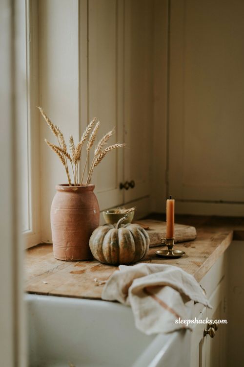 fall kitchen countertop decor grouped in threes with pumpkins crock and candle 