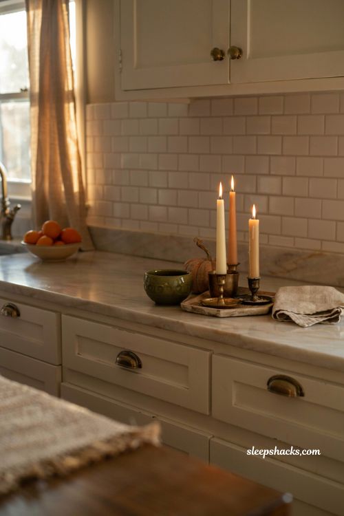 fall kitchen countertop decor with candles at different heights and brass holders