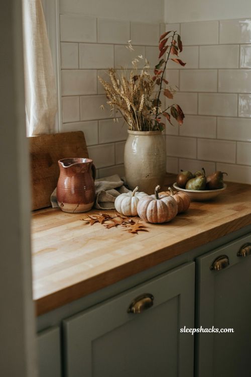 fall kitchen countertop decor with pumpkins and warm autumn accents