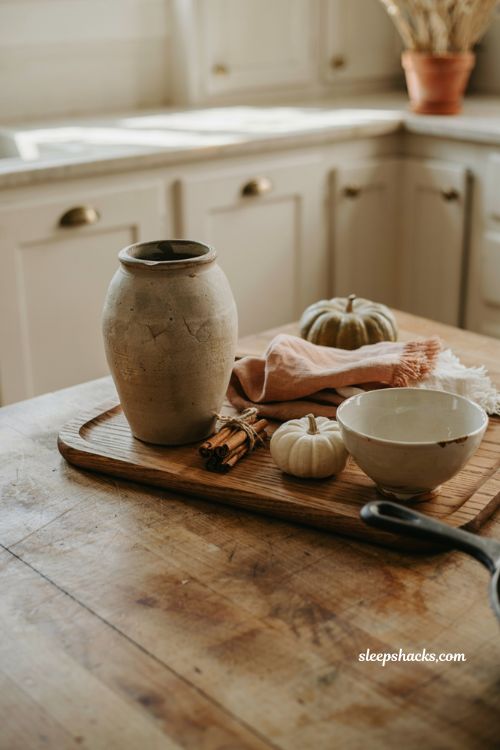 fall kitchen countertop decor with stoneware jar linen napkins and cinnamon sticks