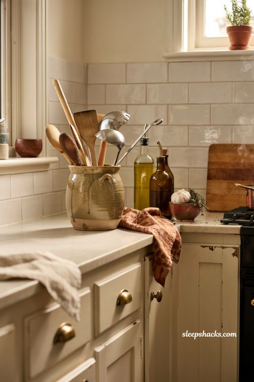 fall kitchen countertop decor with stoneware utensil crock olive oil and rust towel 