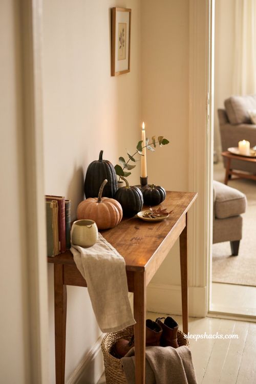 faux pumpkin arrangement on a console table for cozy halloween decor 