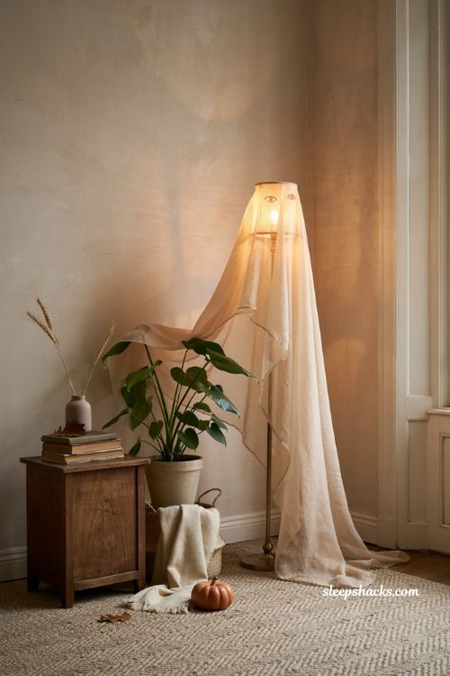 ghost themed corner with sheer fabric for cozy apartment halloween decor 
