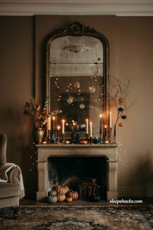 id="74182" Vintage mirror Halloween mantel with candles string lights and pumpkins