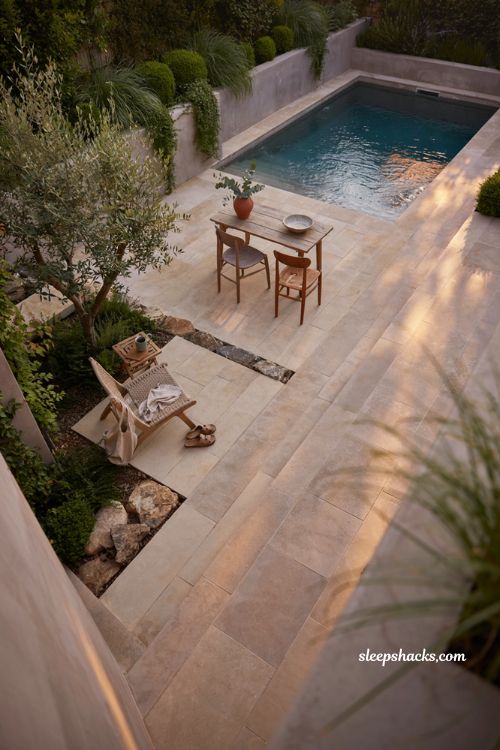 natural oasis small plunge pool ideas with layered greenery and boulder landscaping for backyard