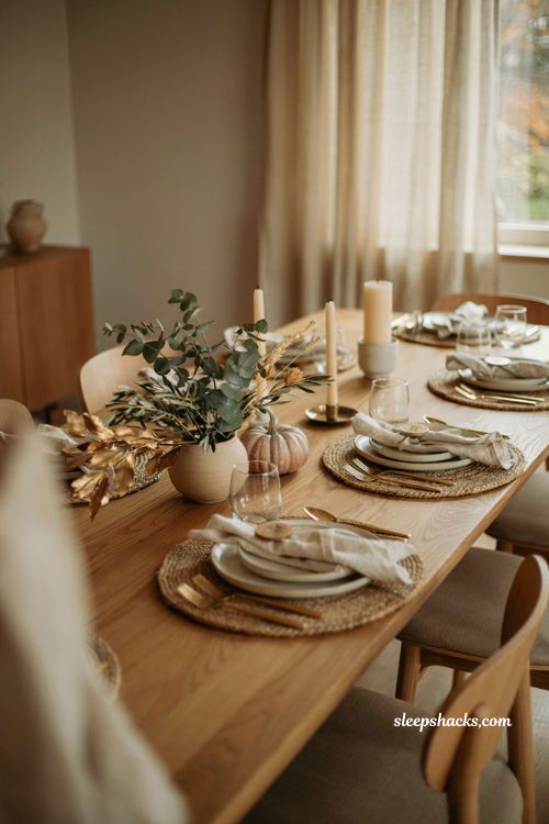 off center Thanksgiving centerpiece with pumpkins and gold leaves modern tablescape