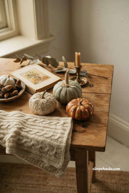 sophisticated diy pumpkin craft ideas displayed on a rustic wooden farmhouse table for grown up fall home decor
